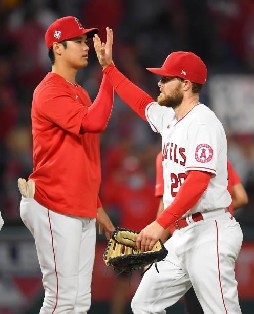 Shohei Ohtani of the Los Angeles Angels gets a high five from Jared Walsh after the game against the Detroit Tigers at Angel Stadium of Anaheim on...
