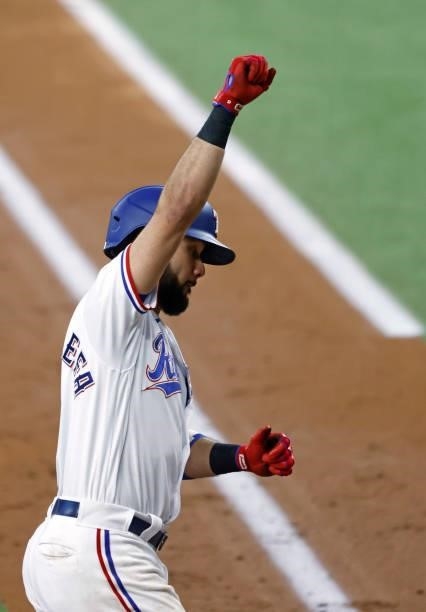 Isiah Kiner-Falefa of the Texas Rangers reacts after hitting a two-run home run against the Minnesota Twins during the third inning at Globe Life...