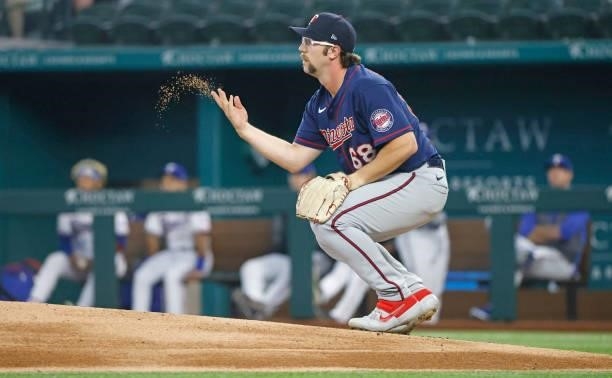 Randy Dobnak of the Minnesota Twins tosses dirt from the mound before pitching during the first inning against the Texas Rangers at Globe Life Field...
