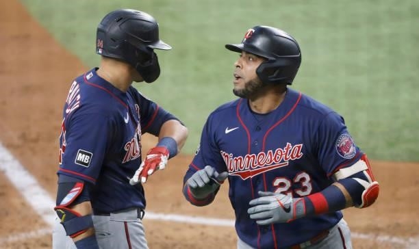 Nelson Cruz of the Minnesota Twins celebrates with teammate Trevor Larnach after hitting a two-run home run against the Texas Rangers during the...