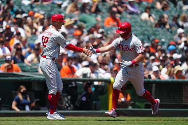 Rhys Hoskins of the Philadelphia Phillies celebrates with Third Base Coach Dusty Wathan after hitting a two run home run during the game between the...