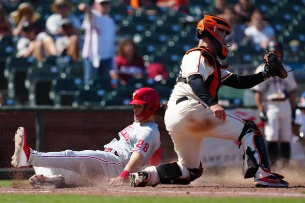 Alec Bohm of the Philadelphia Phillies slides into home during the game between the Philadelphia Phillies and the San Francisco Giants at Oracle Park...