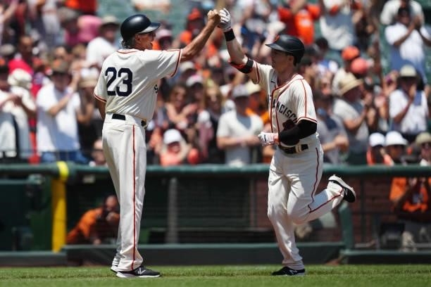 Mike Yastrzemski of the San Francisco Giants celebrates with Third Base Coach Ron Wotus during the game between the Philadelphia Phillies and the San...