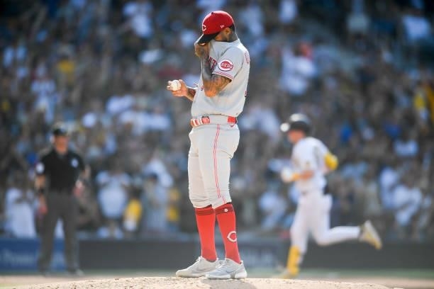 Vladimir Gutierrez of the Cincinnati Reds wipes his face after giving up a two-run home run to Jake Cronenworth of the San Diego Padres during the...