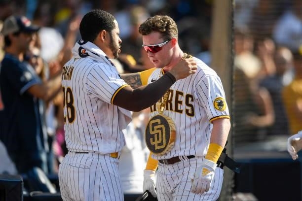 Tommy Pham of the San Diego Padres puts the swag chain on Jake Cronenworth after Cronenworth hit a two-run home run during the third inning of a...