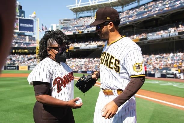 Dr. Alicia Gwynn, wife of Tony Gwynn, meets with Trent Grisham of the San Diego Padres after throwing the ceremonial first pitch before the San Diego...
