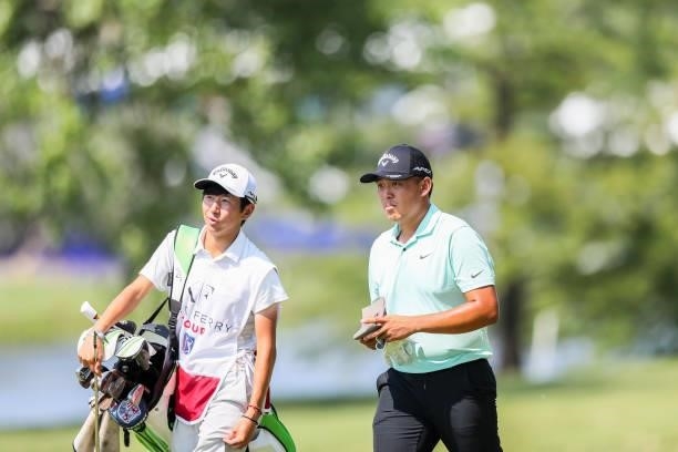 Kevin Yu of Chinese Taipei looks on with his caddie from the 18th hole during the third round of the Wichita Open Benefitting KU Wichita Pediatrics...