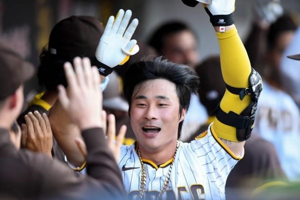 Ha-Seong Kim of the San Diego Padres is congratulated after hitting a two-run home run during the eighth inning of a baseball game against the...