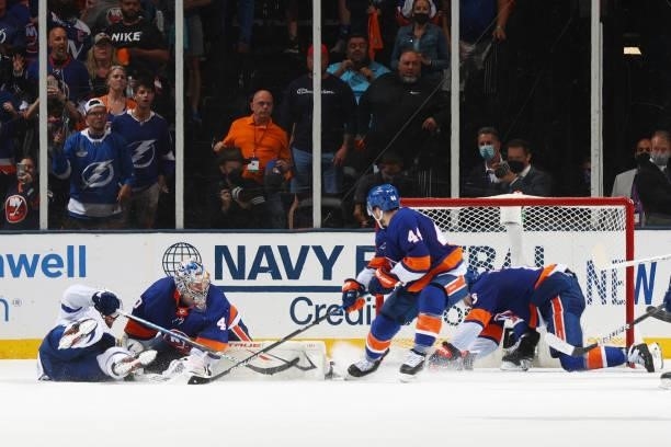 Ryan Pulock of the New York Islanders dives across the crease to make a save with the net open at the end of the third period against Ryan McDonagh...