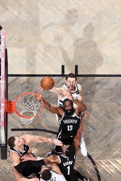 Pat Connaughton of the Milwaukee Bucks and James Harden of the Brooklyn Nets fight for the rebound during the game during Round 2, Game 7 of the 2021...