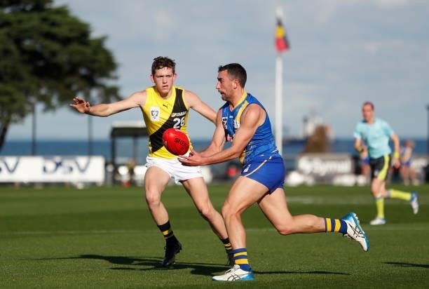 Adam Marcon of the Seagulls is chased by Riley Collier-Dawkins of the Tigers during the VFL Round 10 match between the Williamstown Seagulls and the...