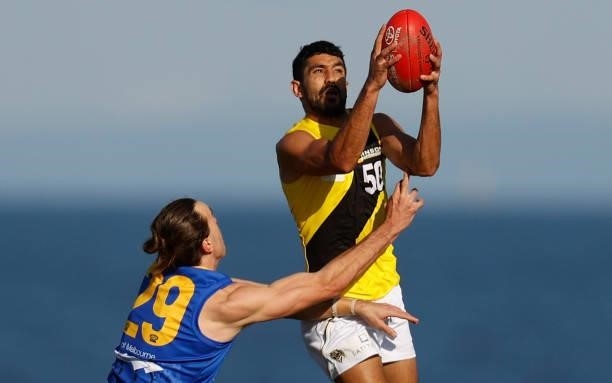 Marlion Pickett of the Tigers and Harrison Macreadie of the Seagulls compete for the ball during the VFL Round 10 match between the Williamstown...