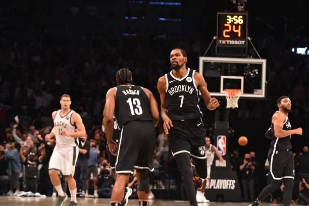 James Harden of the Brooklyn Nets and Kevin Durant of the Brooklyn Nets react during Round 2, Game 7 on June 19, 2021 at Barclays Center in Brooklyn,...