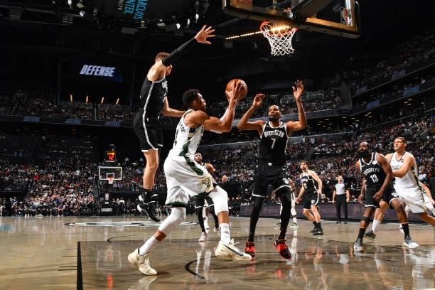 Giannis Antetokounmpo of the Milwaukee Bucks shoots the ball against Kevin Durant of the Brooklyn Nets during Round 2, Game 7 on June 19, 2021 at...