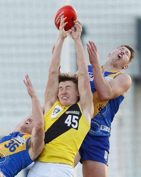 Hugo Ralphsmith of the Tigers competes for the ball against Darby Henderson and Billy Myers of the Seagulls during the VFL Round 10 match between the...