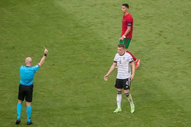 Referee Anthony Taylor and Matthias Ginter of Germany gets the yellow card during the UEFA Euro 2020 Championship Group F match between Portugal and...