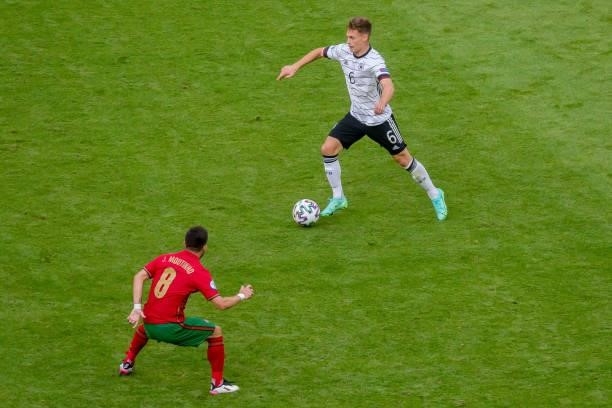Joshua Kimmich of Germany and Joao Moutinho of Portugal battle for the ball during the UEFA Euro 2020 Championship Group F match between Portugal and...
