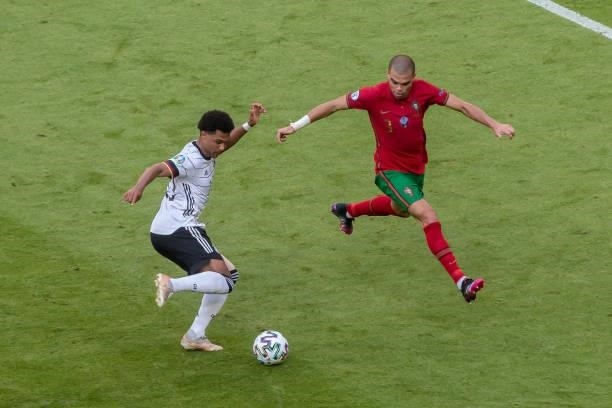 Serge Gnabry of Germany and Pepe of Portugal battle for the ball during the UEFA Euro 2020 Championship Group F match between Portugal and Germany at...