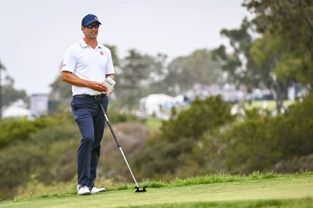 Adam Scott of Australia holds his Topcon green reading book on the 13th hole green during the third round of the 121st U.S. Open on the South Course...