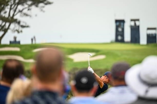Paul Casey of England plays his shot from the 16th tee as fans watch during the third round of the 121st U.S. Open on the South Course at Torrey...