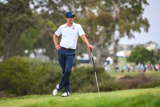 Adam Scott of Australia waits with his putter on the 13th hole green during the third round of the 121st U.S. Open on the South Course at Torrey...