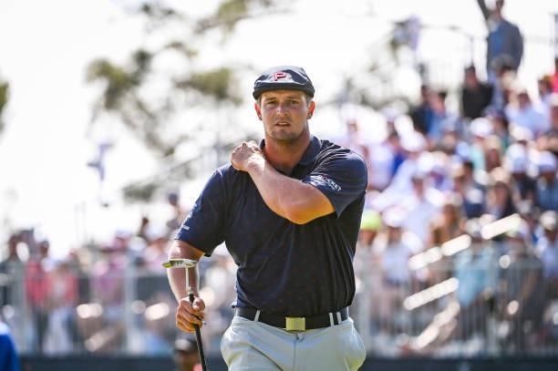 Bryson DeChambeau adjusts his shirt after making a par putt on the 17th hole green during the third round of the 121st U.S. Open on the South Course...