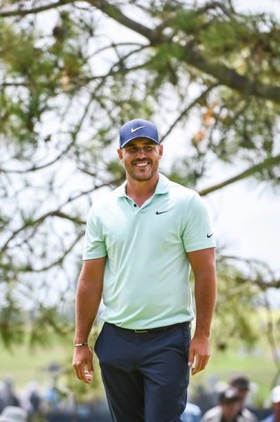 Brooks Koepka smiles after making a birdie putt on the 10th hole green during the third round of the 121st U.S. Open on the South Course at Torrey...