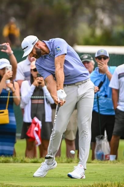 Dustin Johnson at impact as he plays his shot from the 14th tee as fans watch during the third round of the 121st U.S. Open on the South Course at...