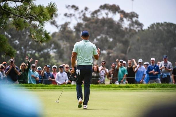 Brooks Koepka waves to fans after making a birdie putt on the 10th hole green during the third round of the 121st U.S. Open on the South Course at...