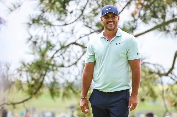 Brooks Koepka smiles after making a birdie putt on the 10th hole green during the third round of the 121st U.S. Open on the South Course at Torrey...