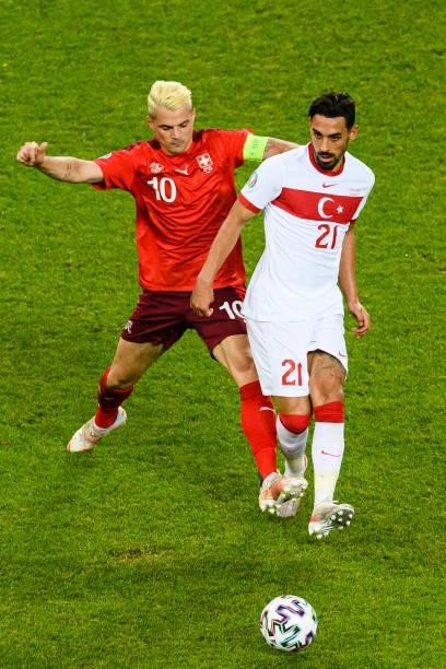 Irfan Can Kahveci of Turkey defends the ball from Granit Xhaka of Switzerland during the UEFA Euro 2020 Championship Group A match between...