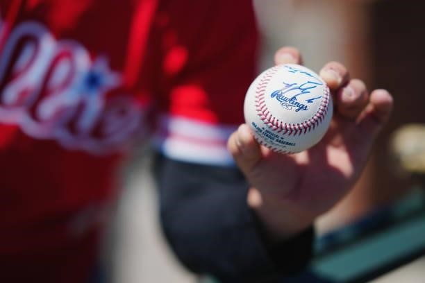Fan holds an autographed ball ahead of the game between the Philadelphia Phillies and the San Francisco Giants at Oracle Park on Sunday, June 20,...