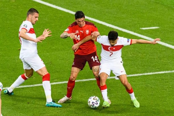Cengiz Under of Turkey fights for the ball with Steven Zuber of Switzerland during the UEFA Euro 2020 Championship Group A match between Switzerland...