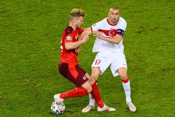 Nico Elvedi of Switzerland fights for the ball with Burak Yilmaz of Turkey during the UEFA Euro 2020 Championship Group A match between Switzerland...