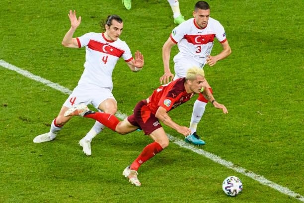 Granit Xhaka of Switzerland is challenged by Caglar Soyuncu of Turkey during the UEFA Euro 2020 Championship Group A match between Switzerland and...