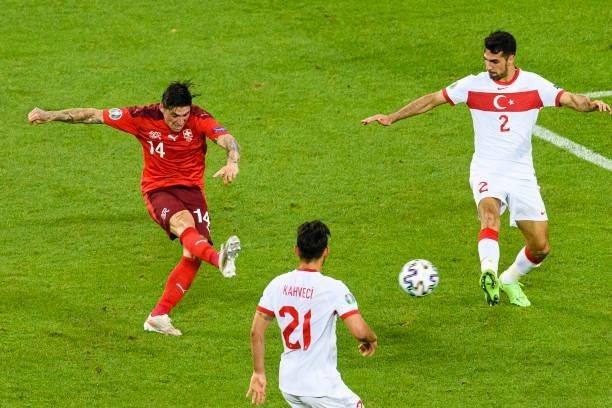 Steven Zuber of Switzerland attempts a kick while being defended by Mehmet Zeki Celik of Turkey during the UEFA Euro 2020 Championship Group A match...