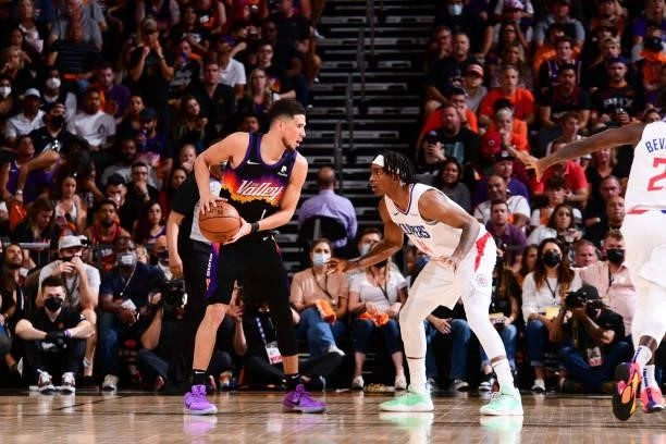 Devin Booker of the Phoenix Suns handles the ball as Terance Mann of the LA Clippers plays defense during the game during Game 1 of the Western...