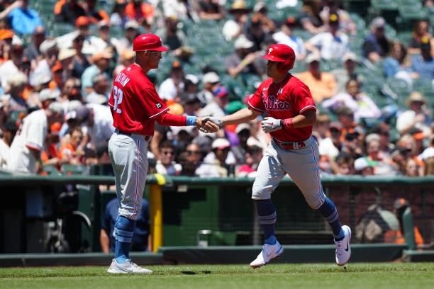 Realmuto of the Philadelphia Phillies celebrates with third base coach Dusty Wathan after hitting a home run during the game between the Philadelphia...