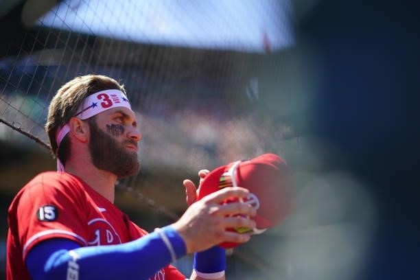 Bryce Harper of the Philadelphia Phillies puts on his hat during the game against the San Francisco Giants at Oracle Park on Sunday, June 20, 2021 in...