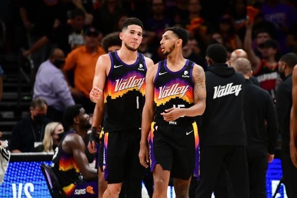 Devin Booker of the Phoenix Suns talks to Cameron Payne of the Phoenix Suns during the game against the LA Clippers during Game 1 of the Western...