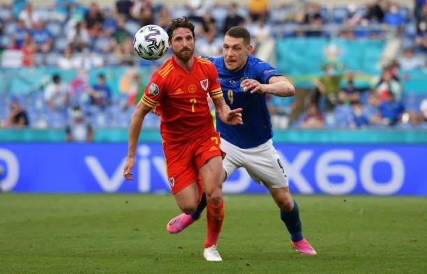Joe Allen of Wales evades challenge from Andrea Belotti of Italy during the UEFA Euro 2020 Championship Group A match between Italy and Wales at...