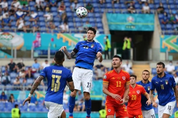 Alessandro Bastoni of Italy clears ball from Kieffer Moore of Wales during the UEFA Euro 2020 Championship Group A match between Italy and Wales at...