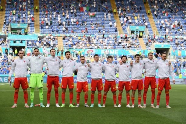 Welsh team sing their national anthem during the UEFA Euro 2020 Championship Group A match between Italy and Wales at Olimpico Stadium on June 20,...