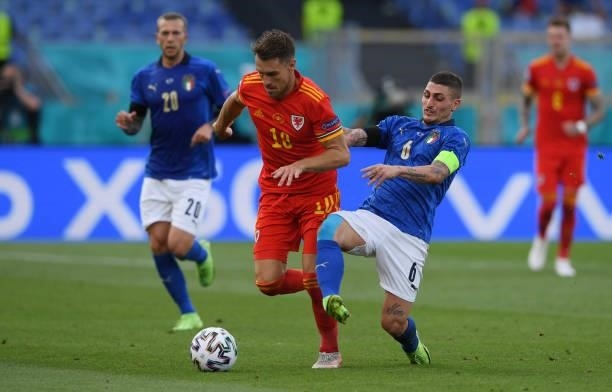 Aaron Ramsey of Wales evades challenge from Marco Verratti of Italy during the UEFA Euro 2020 Championship Group A match between Italy and Wales at...