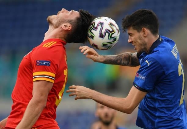 Alessandro Bastoni of Italy battles for the ball with Kieffer Moore of Wales during the UEFA Euro 2020 Championship Group A match between Italy and...