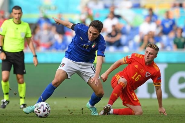 Federico Chiesa of Italy is challenged by Joe Morrell of Wales during the UEFA Euro 2020 Championship Group A match between Italy and Wales at...