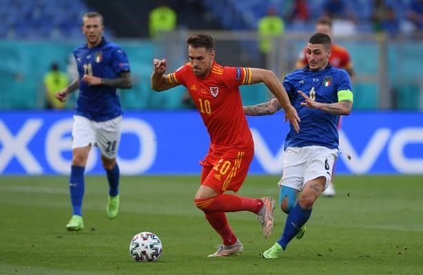 Aaron Ramsey of Wales evades challenge from Marco Verratti of Italy during the UEFA Euro 2020 Championship Group A match between Italy and Wales at...