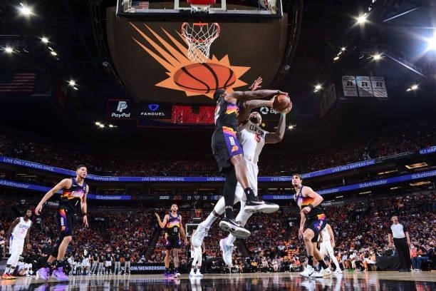DeMarcus Cousins of the LA Clippers drives to the basket during the game as Torrey Craig of the Phoenix Suns plays defense during Game 1 of the...