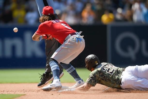 Jonathan India of the Cincinnati Reds fields the throw as Tommy Pham of the San Diego Padres slides into second base with a double during the seventh...