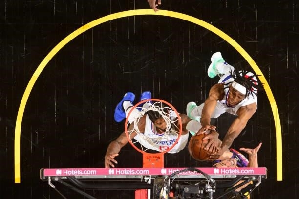Paul George and Terance Mann of the LA Clippers block a shot by Devin Booker of the Phoenix Suns during Game 1 of the Western Conference Finals of...